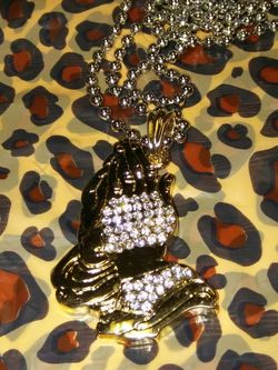 Gold plated prsying hands pendant and chain.