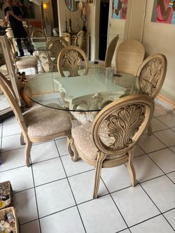 54” glass top dining table with 4 solid wooden chairs . $125