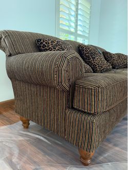 Two large couches with wooden legs