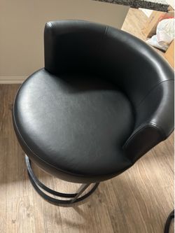 One bar stool in black leather