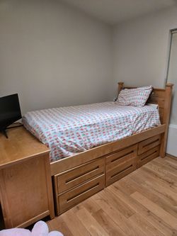 Twin sized wooden bed frame with mattress