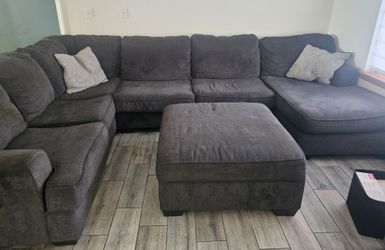 Grey sectional with storage ottoma