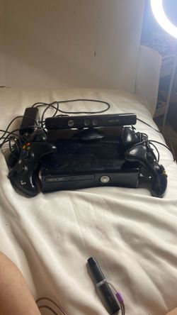 black Microsoft Xbox 360 S console, commonly referred to as the Xbox 360 Slim. With Xbox 360 Kinect