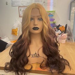 Human hair blend lace front blonde to brown wavy wig.