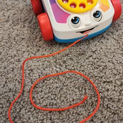969

Fisher-Price Toddler Pull Toy Chatter Telephone Pretend Phone with Rotary Dial and Wheels for Walking Play


