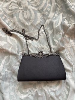 Black clutch with silver chain and pearls