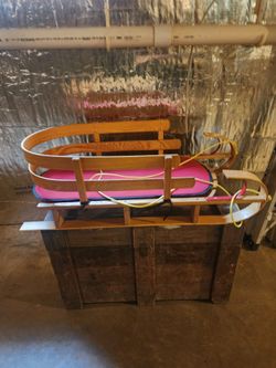 LL Bean kids pull sled with cushion.