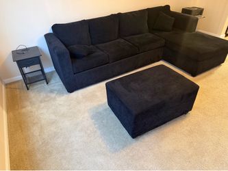 Sectional couch with an ottoman.