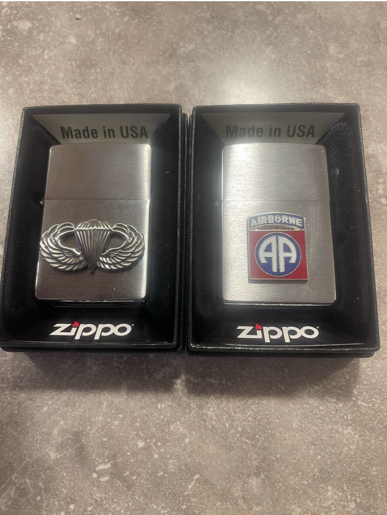 Two zippo military lighters 82nd airborne and jump wings.