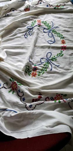 vintage Swedish hand-embroidered tablecloth with intricate cross-stitch floral designs and ribbon motifs