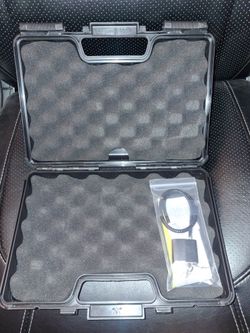 Black lock box for firearm with lock and key.