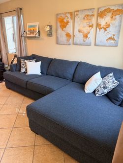 Beautiful Dark Blue sectional couch with extra wide chaise from Jerome’s