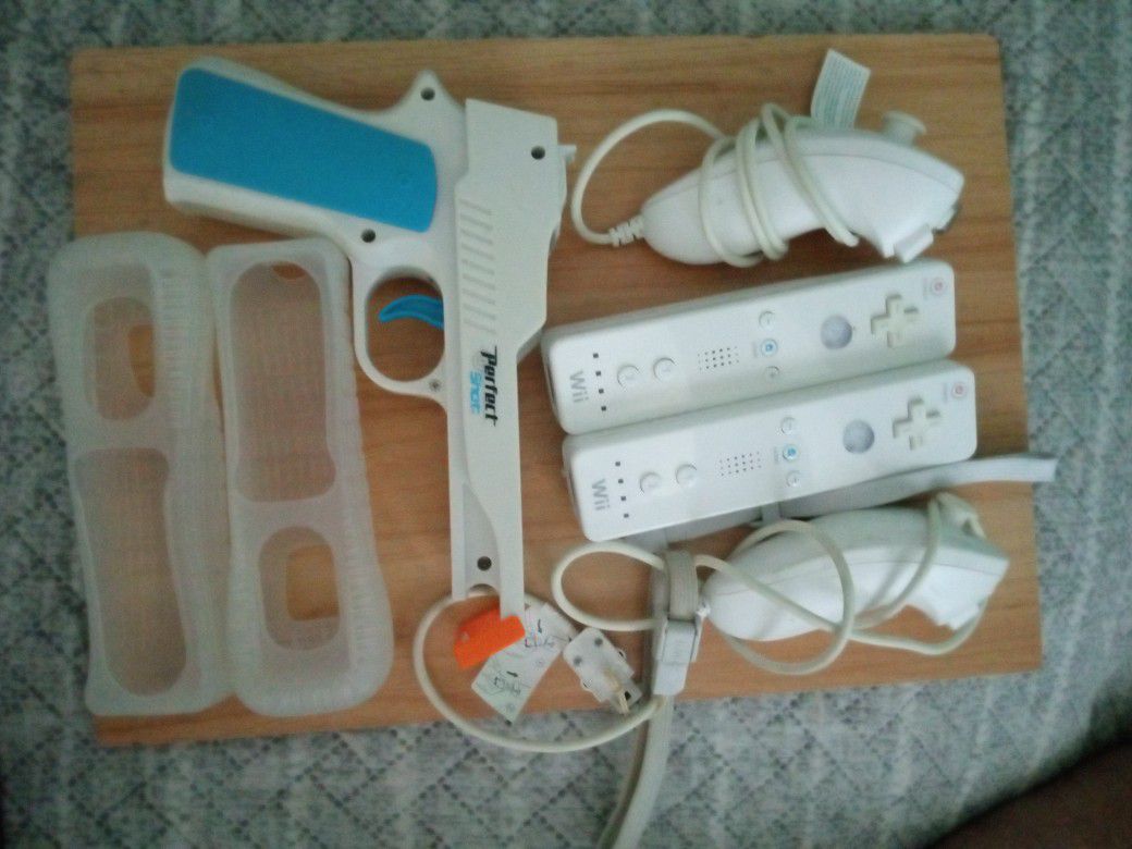 Two Wii Controllers Two Nunchucks And A Perfect Shot gun