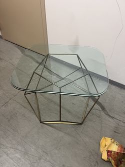 Glass coffee table on golden stand