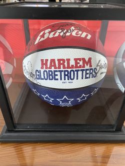Autographed Harlem Globetrotter Basketball in glass case