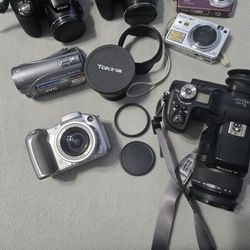 Assorted Cameras And Accessories