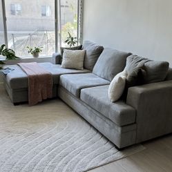 Living Spaces Grey Sectional Sofa with reversible chaise