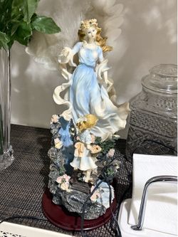 Angel leading  child statue