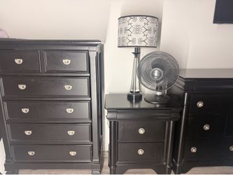 Black bedroom set. Dresser, chest, and nightstand. Includes lamp.