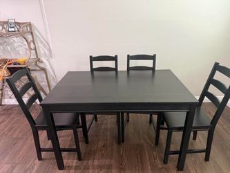 Black IKEA table with 4 chairs