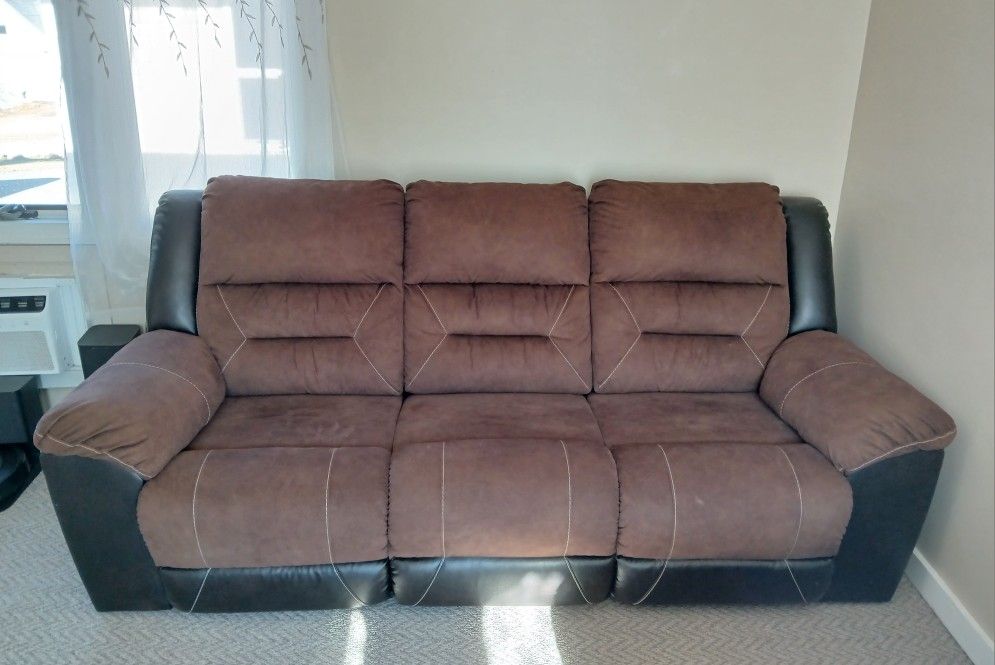 Ashley Earhart Faux Leather Manual Dual Sided Reclining Sofa