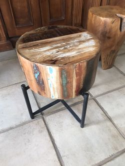 Nice wooden stool with iron base .
