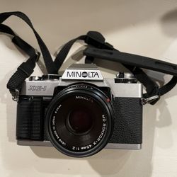 Minolta XG-1 35mm SLR film camera with a 45mm f/2 lens and UV filter.