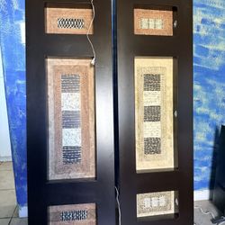 pair of decorative wood wall art panels featuring abstract, textured inserts.