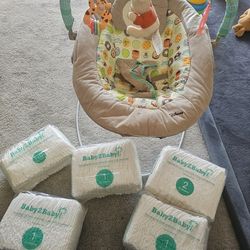 Baby bouncer and diapers