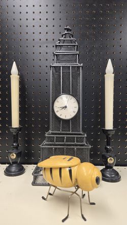 Metal Clock Tower, Ceramic Bee Jar, and Black Candlesticks