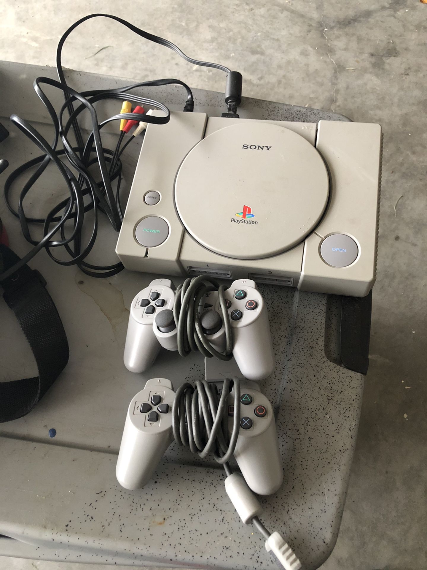 PlayStation (Original) with games and memory cards