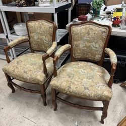 Pair of vintage French Louis XV style armchairs with a carved wood frame and floral tapestry upholstery