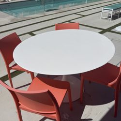Outdoor White Table And Orange Chairs 