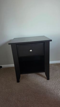 Dark wood nightstand with drawer and lower shelf