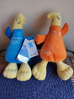 2004 Olympic mascots Athena and Phevos plush toys and bag from the shop they were purchased at.