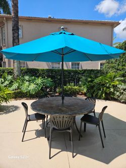 Outdoor dining table with umbrella and 6 chairs