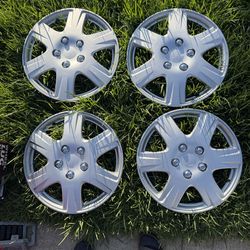 4 hubcaps and 4 stock steel wheels