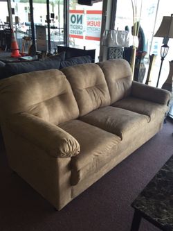Tan sofa and loveseat