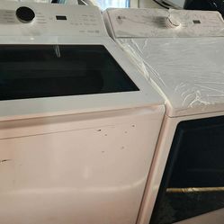 LG 5.5 Cu. Ft. Top Load Washer and 7.3 Cu. Ft. Electric Dryer with AI Sensing in White.