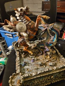 Dragon fighting knight statue with chess board