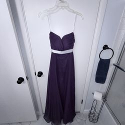 Long purple gown with white sash