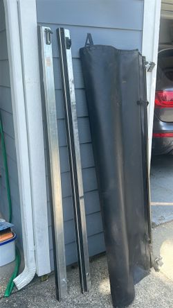 This is a soft roll-up tonneau cover for a pickup truck bed. The kit includes aluminum side rails and a black vinyl cover. Such covers typically attac