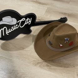 Cowboy Hat with pins and wall decor.