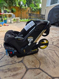 Doona Infant Car Seat & Stroller in the Gold Limited Edition design