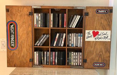 80s vintagewooden wall-mounted cabinet specifically designed for storing and displaying cassette tapes.