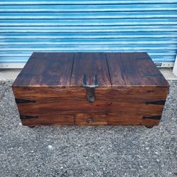 Castrejon trunk style coffee table. Solid wood. Wine storage is removable for more interior storage space 