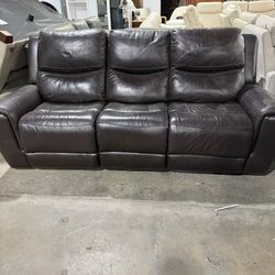 Dark brown leather reclining sofa in good condition