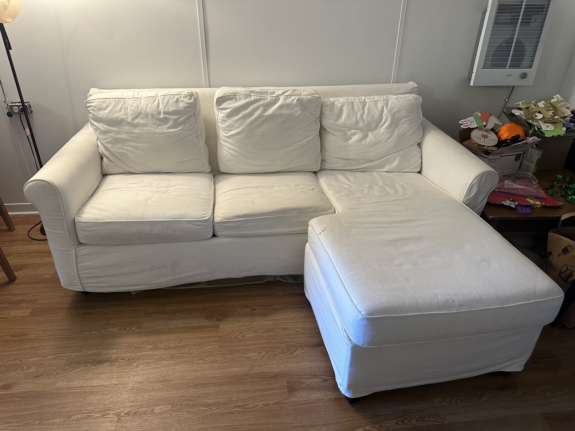 White couch with pull out bed and right trundle