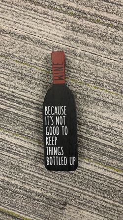 Little wood sign wine bea cause its not good to keep things bottled up