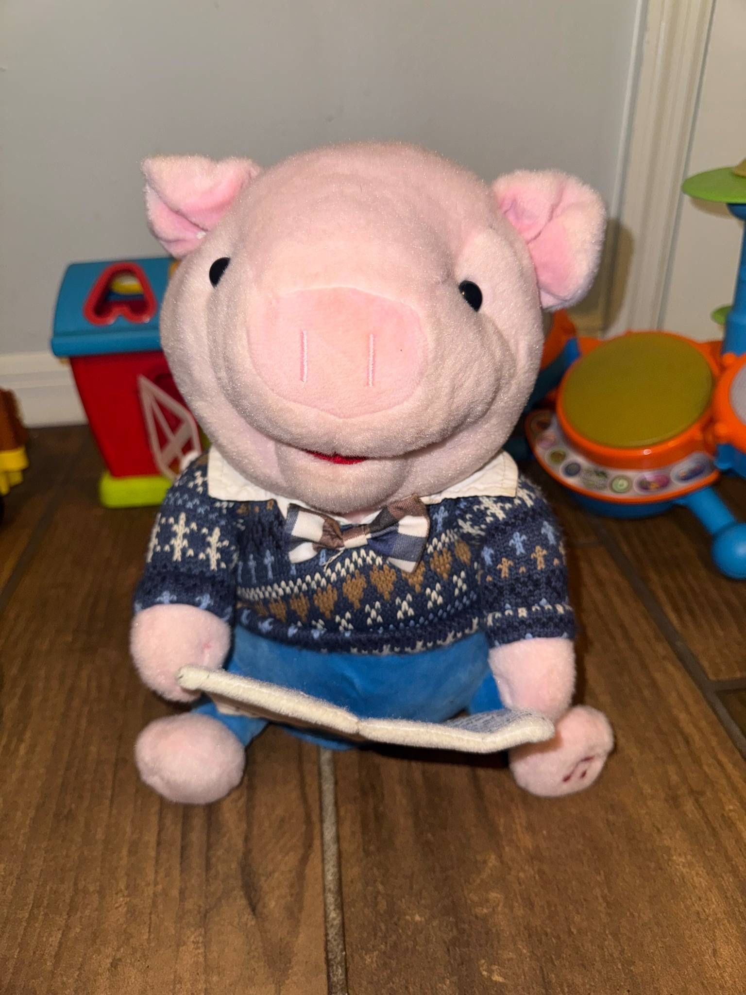 Plush Pig Toy with Blue Sweater reads story